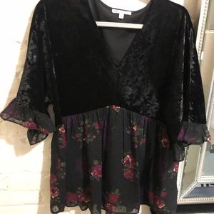 Velvet blouse with flower detailing at bottom.